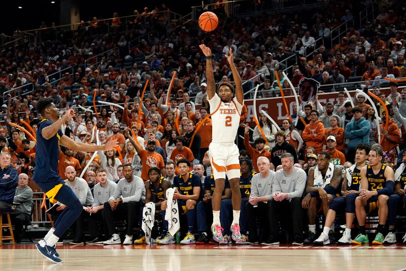 Feb 11, 2023; Austin, Texas, USA; Texas Longhorns guard Arterio Morris (2) shoots a three point basket over West Virginia Mountaineers forward Mohamed Wague (11) during the first half at Moody Center. Mandatory Credit: Scott Wachter-USA TODAY Sports