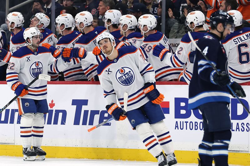 Dec 29, 2025; Winnipeg, Manitoba, CAN; Edmonton Oilers center Jack Roslovic (28) celebrates a goal against the Winnipeg Jets in the second period at Canada Life Centre. Mandatory Credit: James Carey Lauder-Imagn Images