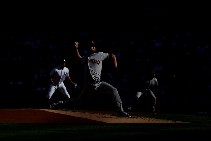 Apr 1, 2023; Bronx, New York, USA; San Francisco Giants starting pitcher Alex Cobb (38) pitches as New York Yankees right fielder Giancarlo Stanton (27) leads from first base during the first inning at Yankee Stadium. Mandatory Credit: Brad Penner-USA TODAY Sports