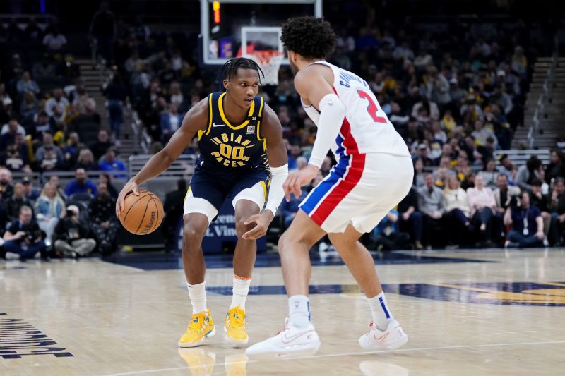 INDIANAPOLIS, INDIANA - FEBRUARY 22: Bennedict Mathurin #00 of the Indiana Pacers dribbles the ball while being guarded by Cade Cunningham #2 of the Detroit Pistons in the second quarter at Gainbridge Fieldhouse on February 22, 2024 in Indianapolis, Indiana. NOTE TO USER: User expressly acknowledges and agrees that, by downloading and or using this photograph, User is consenting to the terms and conditions of the Getty Images License Agreement. (Photo by Dylan Buell/Getty Images)