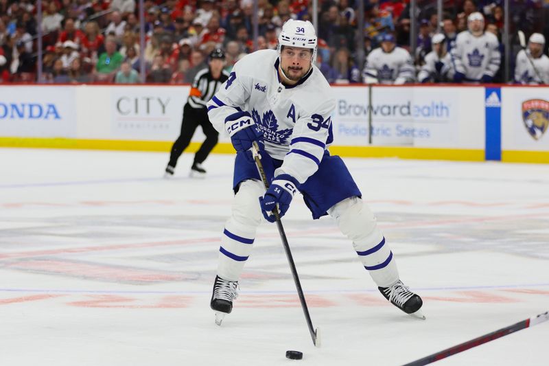 Apr 16, 2024; Sunrise, Florida, USA; Toronto Maple Leafs center Auston Matthews (34) moves the puck against the Florida Panthers during the third period at Amerant Bank Arena. Mandatory Credit: Sam Navarro-USA TODAY Sports