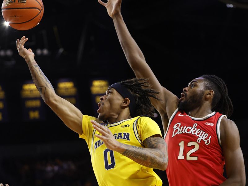 Jan 15, 2024; Ann Arbor, Michigan, USA; Michigan Wolverines guard Dug McDaniel (0) shoots as Ohio State Buckeyes guard Evan Mahaffey (12) defends in the first half at Crisler Center. Mandatory Credit: Rick Osentoski-USA TODAY Sports