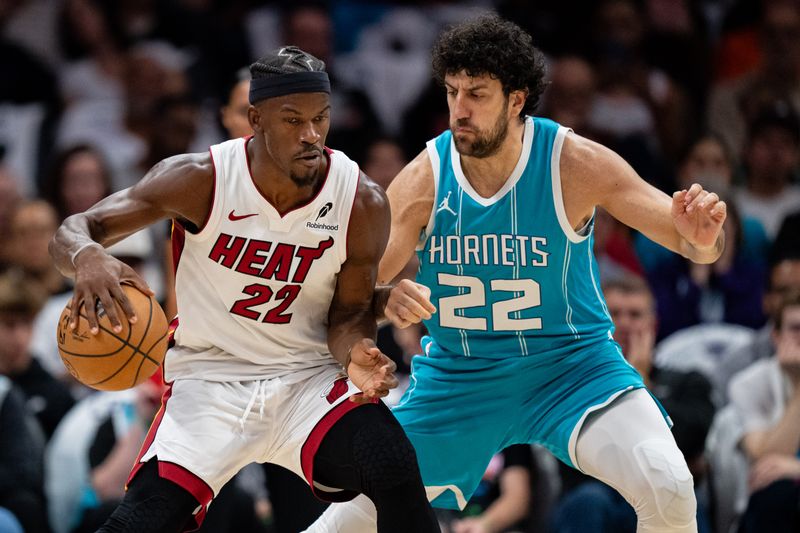 CHARLOTTE, NORTH CAROLINA - OCTOBER 26: Vasilije Micic #22 of the Charlotte Hornets guards Jimmy Butler #22 of the Miami Heat in the first quarter during their game at Spectrum Center on October 26, 2024 in Charlotte, North Carolina. NOTE TO USER: User expressly acknowledges and agrees that, by downloading and or using this photograph, User is consenting to the terms and conditions of the Getty Images License Agreement. (Photo by Jacob Kupferman/Getty Images)