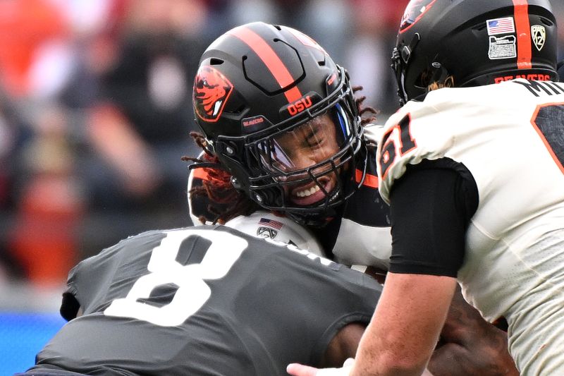 Sep 23, 2023; Pullman, Washington, USA; Oregon State Beavers running back Damien Martinez (6) is stopped by Washington State Cougars linebacker Devin Richardson (8) in the first half at Gesa Field at Martin Stadium. Mandatory Credit: James Snook-USA TODAY Sports