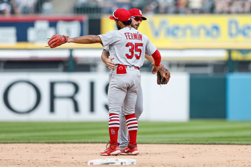 Jul 9, 2023; Chicago, Illinois, USA; St. Louis Cardinals shortstop Paul DeJong (11) celebrates with shortstop Jose Fermin (35) after defeating the Chicago White Sox at Guaranteed Rate Field. Mandatory Credit: Kamil Krzaczynski-USA TODAY Sports