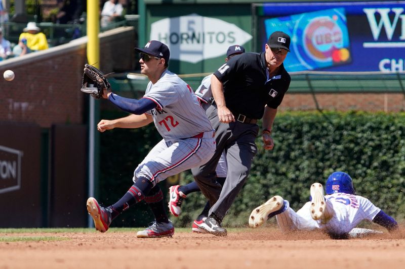 Aug 7, 2024; Chicago, Illinois, USA; Chicago Cubs outfielder Pete Crow-Armstrong (52) steals second base against Minnesota Twins second baseman Brooks Lee (72) during the third inning at Wrigley Field. Mandatory Credit: David Banks-USA TODAY Sports