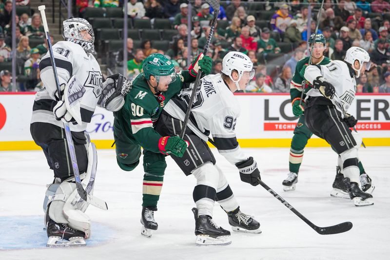 Nov 5, 2024; Saint Paul, Minnesota, USA; Los Angeles Kings defenseman Brandt Clarke (92) defends against the Minnesota Wild center Marcus Johansson (90) in the second period at Xcel Energy Center. Mandatory Credit: Brad Rempel-Imagn Images