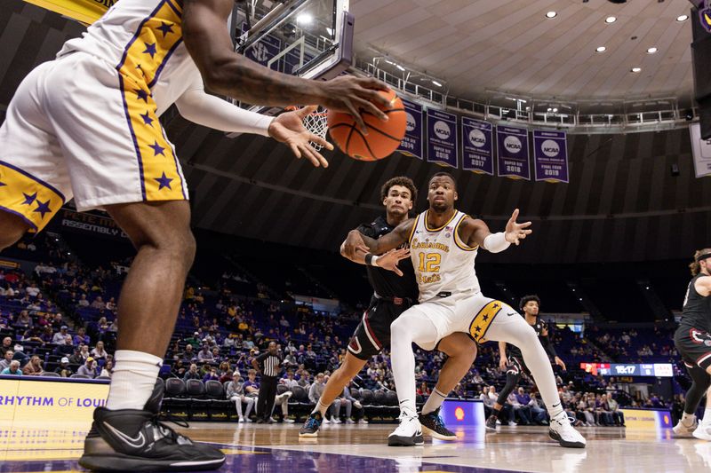 Feb 18, 2023; Baton Rouge, Louisiana, USA; LSU Tigers guard Trae Hannibal (0) passes the ball inbounds to forward KJ Williams (12) against the South Carolina Gamecocks at Pete Maravich Assembly Center. Mandatory Credit: Stephen Lew-USA TODAY Sports