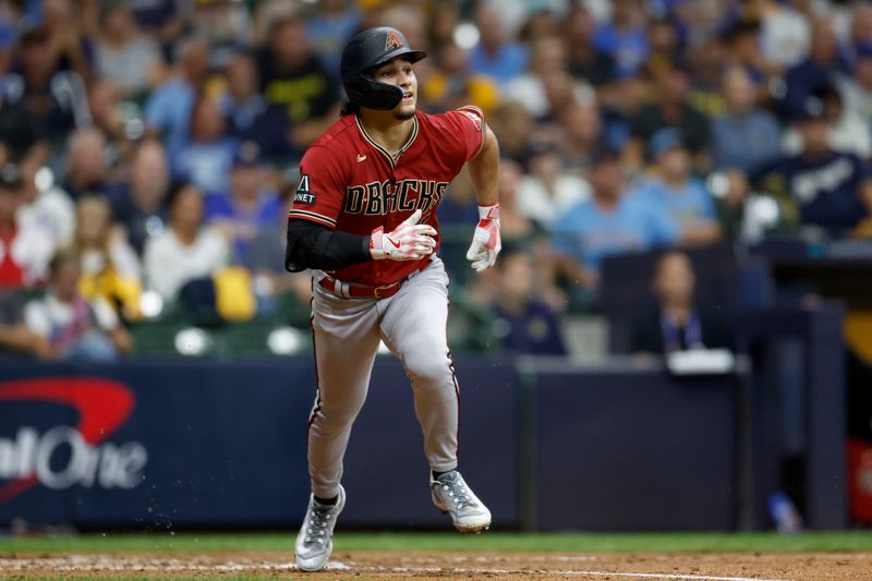 Oct 4, 2023; Milwaukee, Wisconsin, USA; Arizona Diamondbacks center fielder Alek Thomas (5) hits a home run in the fifth inning against the Milwaukee Brewers during game two of the Wildcard series for the 2023 MLB playoffs at American Family Field. Mandatory Credit: Kamil Krzaczynski-USA TODAY Sports