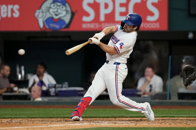 May 29, 2024; Arlington, Texas, USA; Texas Rangers third baseman Josh Smith (8) hits a single against the Arizona Diamondbacks during the eighth inning at Globe Life Field. Mandatory Credit: Jim Cowsert-USA TODAY Sports