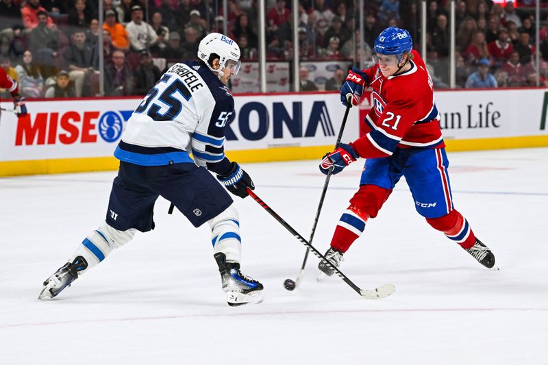 Oct 28, 2023; Montreal, Quebec, CAN; Montreal Canadiens defenseman Kaiden Guhle (21) shoots the puck as Winnipeg Jets center Mark Scheifele (55) defends during overtime at Bell Centre. Mandatory Credit: David Kirouac-USA TODAY Sports