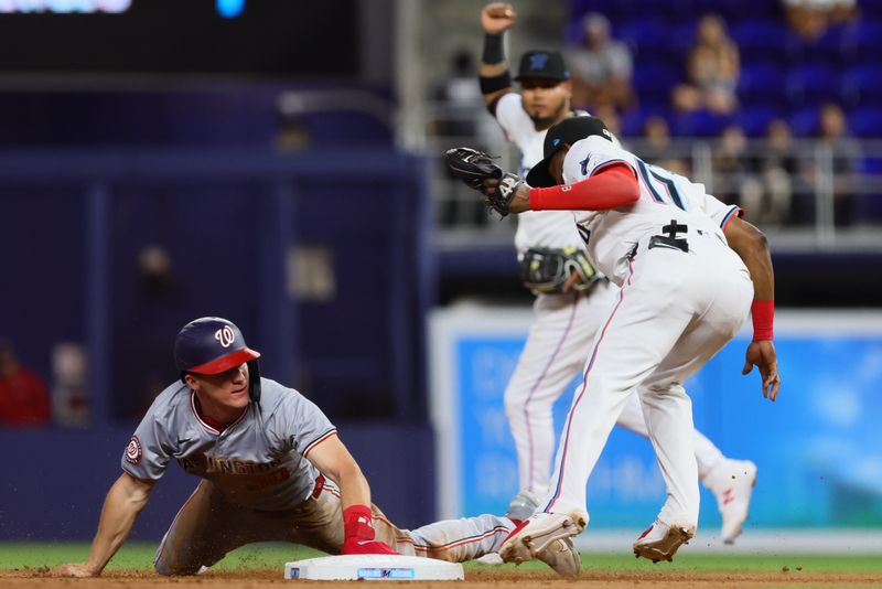 Apr 29, 2024; Miami, Florida, USA; Washington Nationals center fielder Jacob Young (30) watches after stealing second base against Miami Marlins shortstop Vidal Brujan (17) during the seventh inning at loanDepot Park. Mandatory Credit: Sam Navarro-USA TODAY Sports