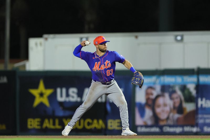 Mar 8, 2024; Jupiter, Florida, USA; New York Mets second baseman Yolmer Sanchez (83) throws to first base against the Miami Marlins during the fourth inning at Roger Dean Chevrolet Stadium. Mandatory Credit: Sam Navarro-USA TODAY Sports