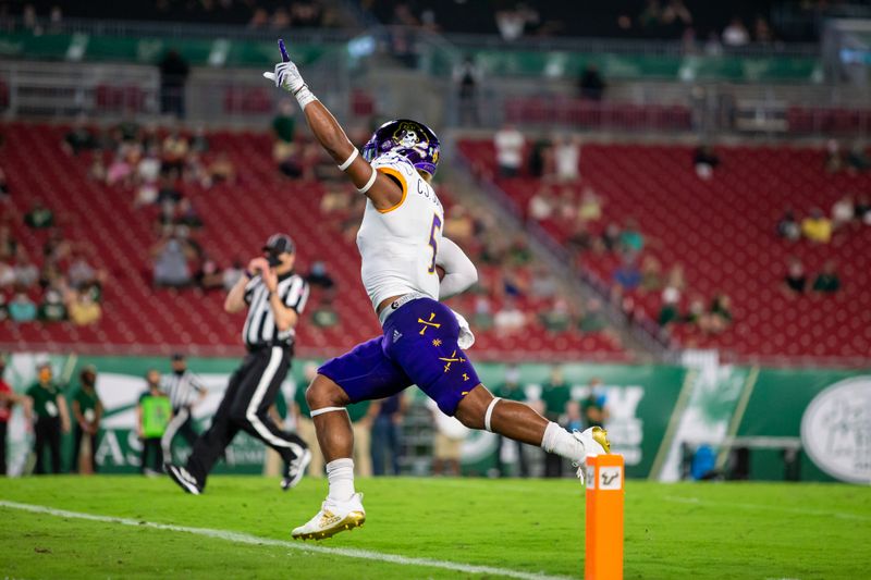 Oct 10, 2020; Tampa, Florida, USA; East Carolina Pirates wide receiver C.J. Johnson (5) scores a touchdown during the first quarter of a game against the South Florida Bulls at Raymond James Stadium. Mandatory Credit: Mary Holt-USA TODAY Sports