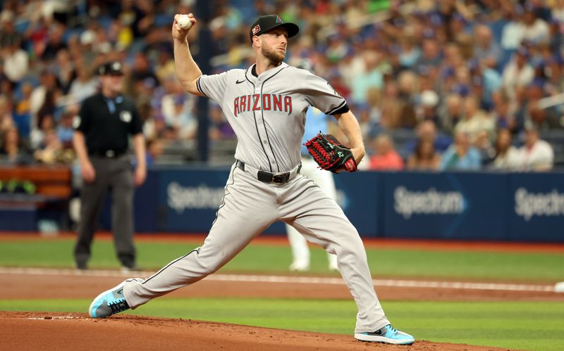 Aug 18, 2024; St. Petersburg, Florida, USA;  Arizona Diamondbacks starting pitcher Merrill Kelly (29) throws a pitch against the Tampa Bay Rays during the first inning at Tropicana Field. Mandatory Credit: Kim Klement Neitzel-USA TODAY Sports