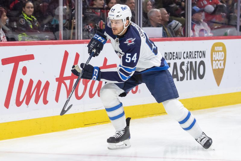 Jan 20, 2024; Ottawa, Ontario, CAN; Winnipeg Jets defenseman Dylan Samberg (54) chases the puck in the first period against the Ottawa Senators at the Canadian Tire Centre. Mandatory Credit: Marc DesRosiers-USA TODAY Sports