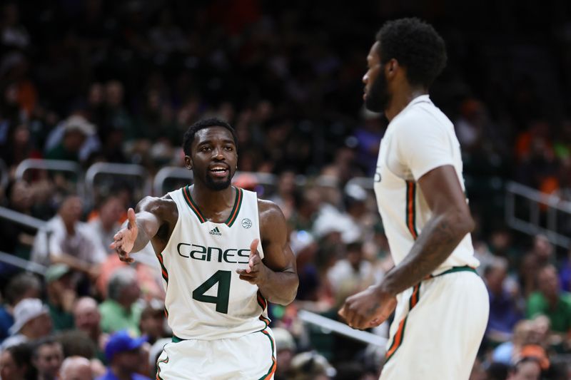 Jan 27, 2024; Coral Gables, Florida, USA; Miami Hurricanes guard Bensley Joseph (4) reacts toward guard Wooga Poplar (5) during the first half at Watsco Center. Mandatory Credit: Sam Navarro-USA TODAY Sports