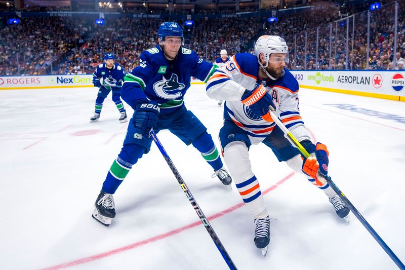 May 20, 2024; Vancouver, British Columbia, CAN; Vancouver Canucks forward Ilya Mikheyev (65) checks Edmonton Oilers forward Leon Draisaitl (29) during the third period in game seven of the second round of the 2024 Stanley Cup Playoffs at Rogers Arena. Mandatory Credit: Bob Frid-USA TODAY Sports