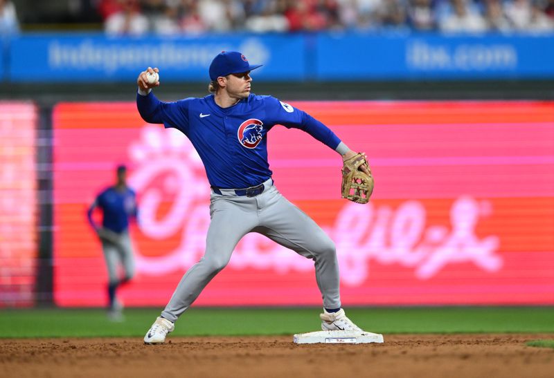 Sep 24, 2024; Philadelphia, Pennsylvania, USA; Chicago Cubs infielder Nico Hoerner (2) turns a double play against the Philadelphia Phillies in the sixth inning at Citizens Bank Park. Mandatory Credit: Kyle Ross-Imagn Images