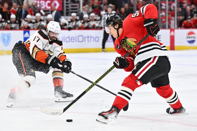 Dec 7, 2023; Chicago, Illinois, USA; Chicago Blackhawks forward Connor Bedard (98) stick handles as Anaheim Ducks forward Alex Killorn (17) defends in the third period at United Center. Mandatory Credit: Jamie Sabau-USA TODAY Sports