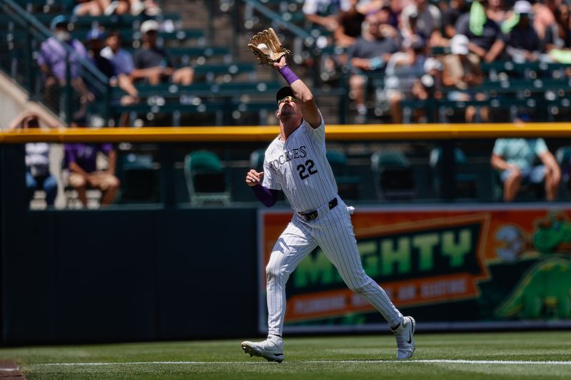 Jun 23, 2024; Denver, Colorado, USA; Colorado Rockies left fielder Nolan Jones (22) makes a catch in the third inning against the Washington Nationals at Coors Field. Mandatory Credit: Isaiah J. Downing-USA TODAY Sports