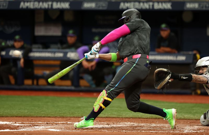 Aug 17, 2024; St. Petersburg, Florida, USA;  Tampa Bay Rays first base Yandy Diaz (2) hits a 2-RBI single against the Arizona Diamondbacks during the second inning at Tropicana Field. Mandatory Credit: Kim Klement Neitzel-USA TODAY Sports