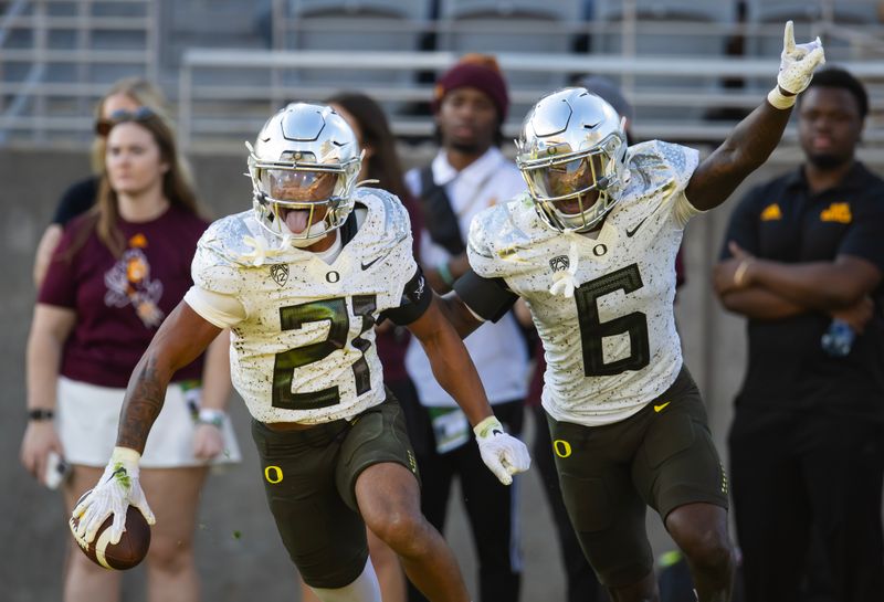 Nov 18, 2023; Tempe, Arizona, USA; Oregon Ducks defensive back Cole Martin (21) celebrates an interception with teammate Jahlil Florence (6) against the Arizona State Sun Devils in the second half at Mountain America Stadium. Mandatory Credit: Mark J. Rebilas-USA TODAY Sports