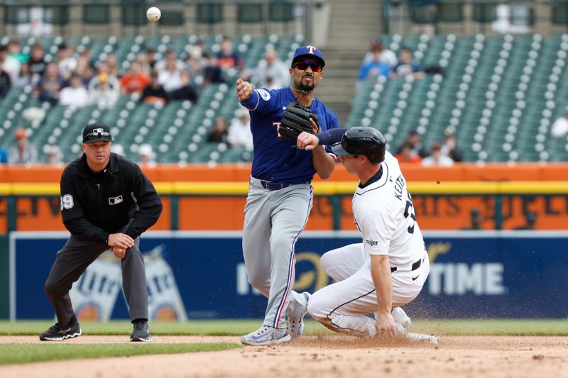 Apr 17, 2024; Detroit, Michigan, USA; Texas Rangers second baseman Marcus Semien (2) throws to first after tagging out Detroit Tigers second baseman Colt Keith (33) at second base during the second inning of the game at Comerica Park. Mandatory Credit: Brian Bradshaw Sevald-USA TODAY Sports