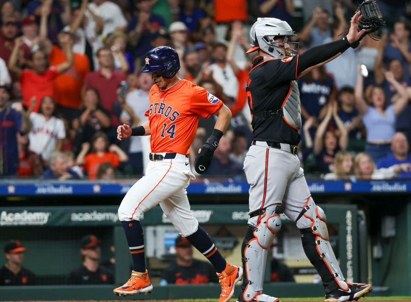 Jun 21, 2024; Houston, Texas, USA; Houston Astros shortstop Mauricio Dubon (14) scores on left fielder Joey Loperfido (10) (not pictured) RBI double in the sixth inning at Minute Maid Park. Mandatory Credit: Thomas Shea-USA TODAY Sports