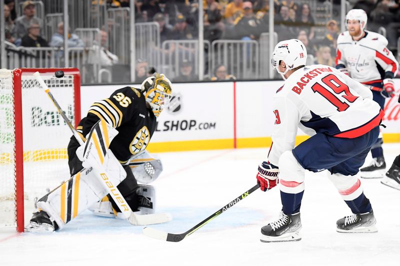 Oct 3, 2023; Boston, Massachusetts, USA;  Washington Capitals center Nicklas Backstrom (19) shoots the puck over the net past Boston Bruins goaltender Linus Ullmark (35) during the second period at TD Garden. Mandatory Credit: Bob DeChiara-USA TODAY Sports