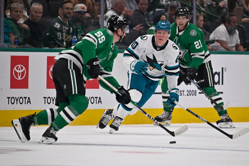 Oct 15, 2024; Dallas, Texas, USA; Dallas Stars defenseman Thomas Harley (55) looks to move the puck past San Jose Sharks left wing Fabian Zetterlund (20) during the first period at the American Airlines Center. Mandatory Credit: Jerome Miron-Imagn Images