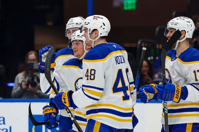 Feb 28, 2026; Tampa, Florida, USA; Buffalo Sabres defenseman Zach Metsa (73) celebrates a goal with forward Jack Quinn (22), and forward Tyson Kozak (48) and forward Jason Zucker (17) against the Tampa Bay Lightning during the second period at Benchmark International Arena. Mandatory Credit: Morgan Tencza-Imagn Images