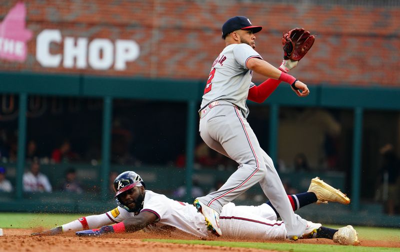 May 27, 2024; Cumberland, Georgia, USA; Atlanta Braves designated hitter Marcell Ozuna (20) slides into second base under Washington Nationals second baseman Luis García Jr. (2) during the seventh inning at Truist Park. Mandatory Credit: John David Mercer-USA TODAY Sports