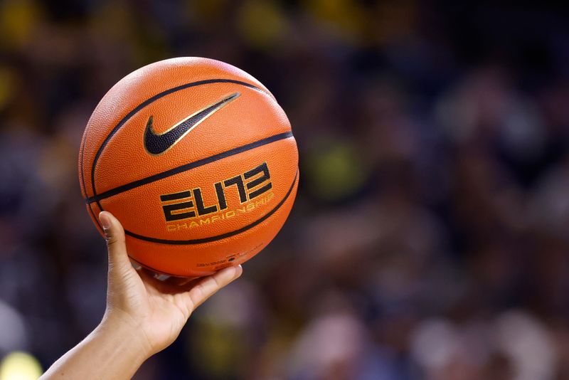 Feb 24, 2026; Ann Arbor, Michigan, USA; A referee holds up a ball in the first half between the Michigan Wolverines and the Minnesota Golden Gophers at Crisler Center. Mandatory Credit: Rick Osentoski-Imagn Images