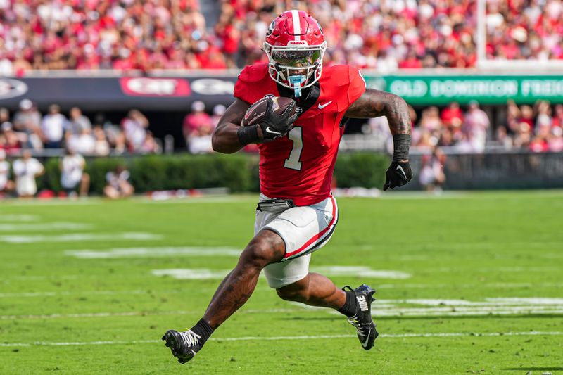 Oct 5, 2024; Athens, Georgia, USA; Georgia Bulldogs running back Trevor Etienne (1) runs against the Auburn Tigers during the first quarter at Sanford Stadium. Mandatory Credit: Dale Zanine-Imagn Images