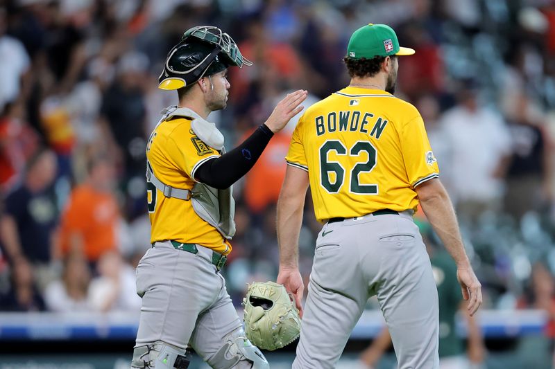 Jul 27, 2025; Houston, Texas, USA; Athletics relief pitcher Ben Bowden (62) is congratulated by Athletics catcher Austin Wynns (29) after the final out against the Houston Astros during the ninth inning at Daikin Park. Mandatory Credit: Erik Williams-Imagn Images