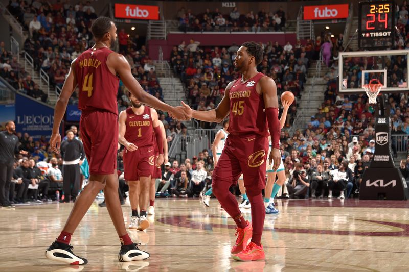 CLEVELAND, OH - JANUARY 5: Evan Mobley #4 and Donovan Mitchell #45 of the Cleveland Cavaliers high five during the game against the Charlotte Hornets on January 5, 2025 at Rocket Mortgage FieldHouse in Cleveland, Ohio. NOTE TO USER: User expressly acknowledges and agrees that, by downloading and/or using this Photograph, user is consenting to the terms and conditions of the Getty Images License Agreement. Mandatory Copyright Notice: Copyright 2025 NBAE (Photo by David Liam Kyle/NBAE via Getty Images)