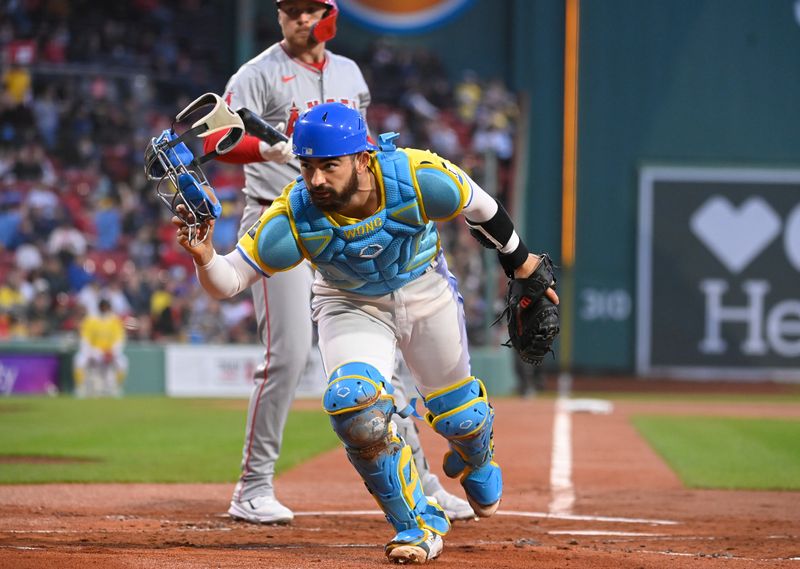 Apr 12, 2024; Boston, Massachusetts, USA; Boston Red Sox catcher Connor Wong (12) looks for the ball during the first inning against the Los Angeles Angels at Fenway Park. Mandatory Credit: Eric Canha-USA TODAY Sports