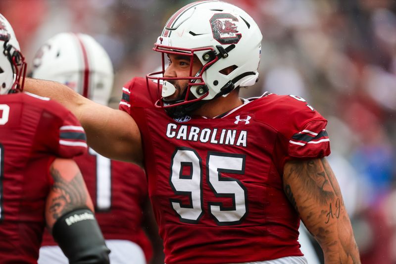 Nov 11, 2023; Columbia, South Carolina, USA; South Carolina Gamecocks defensive tackle Alex Huntley (95) celebrates after making a touchdown reception on offense against the Vanderbilt Commodores in the first quarter at Williams-Brice Stadium. Mandatory Credit: Jeff Blake-USA TODAY Sports