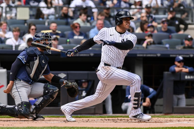 Apr 20, 2024; Bronx, New York, USA; New York Yankees outfielder Juan Soto (22) hits a single against the Tampa Bay Rays during the first inning at Yankee Stadium. Mandatory Credit: John Jones-USA TODAY Sports