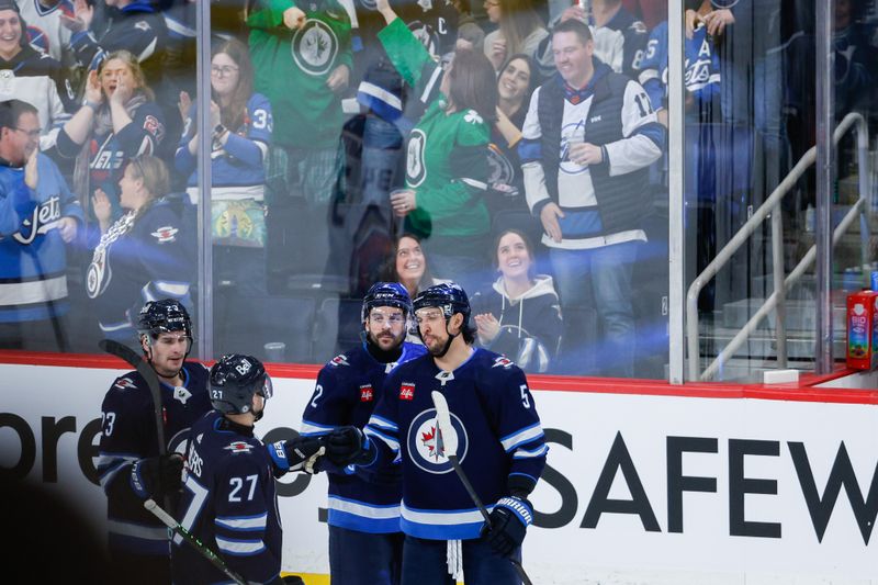 Mar 15, 2024; Winnipeg, Manitoba, CAN; Winnipeg Jets defenseman Dylan DeMelo (2) is congratulated by his team mates on his goal against the Anaheim Ducks during the third period at Canada Life Centre. Mandatory Credit: Terrence Lee-USA TODAY Sports