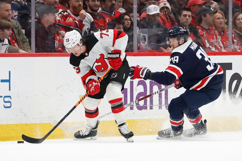 Feb 20, 2024; Washington, District of Columbia, USA; New Jersey Devils right wing Tyler Toffoli (73) skates with the puck as Washington Capitals right wing Anthony Mantha (39) defends in the second period at Capital One Arena. Mandatory Credit: Geoff Burke-USA TODAY Sports