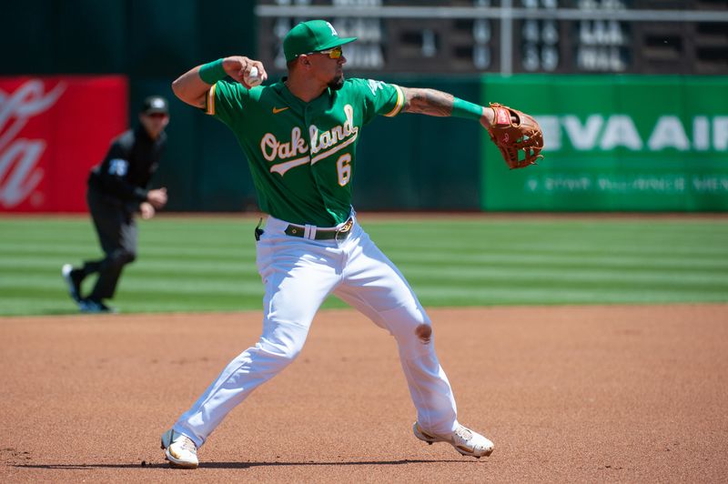 Apr 29, 2023; Oakland, California, USA; Oakland Athletics third baseman Jace Peterson (6) throws to first base after fielding a ground ball during the first inning against the Cincinnati Reds at RingCentral Coliseum. Mandatory Credit: Ed Szczepanski-USA TODAY Sports