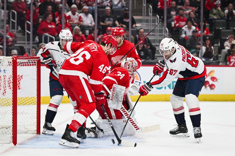 Feb 27, 2024; Detroit, Michigan, USA; Washington Capitals left wing Max Pacioretty (67) scores a goal as Detroit Red Wings goaltender Alex Lyon (34) and defenseman Jeff Petry (46) attempt to defend the net during the third period at Little Caesars Arena. Mandatory Credit: Tim Fuller-USA TODAY Sports