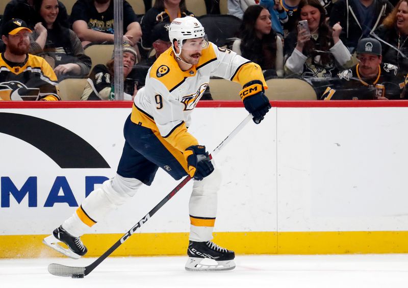 Apr 15, 2024; Pittsburgh, Pennsylvania, USA;  Nashville Predators left wing Filip Forsberg (9) passes the puck against the Pittsburgh Penguins during the third period at PPG Paints Arena. The Penguins won 4-2. Mandatory Credit: Charles LeClaire-USA TODAY Sports