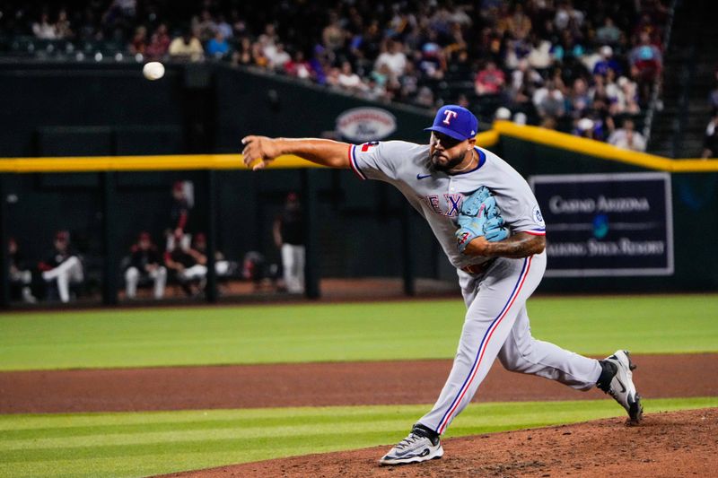 Sep 2, 2025; Phoenix, Arizona, USA; Texas Rangers pitcher Luis Curvelo (57) pitches in the sixth inning of the game between Arizona Diamondbacks and Texas Rangers at Chase Field. Mandatory Credit: Arianna Grainey-Imagn Images