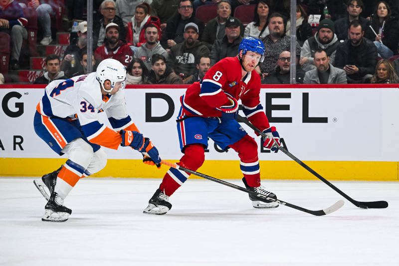 Dec 3, 2024; Montreal, Quebec, CAN; Montreal Canadiens defenseman Mike Matheson (8) plays the puck against New York Islanders defenseman Grant Hutton (34) during the first period at Bell Centre. Mandatory Credit: David Kirouac-Imagn Images