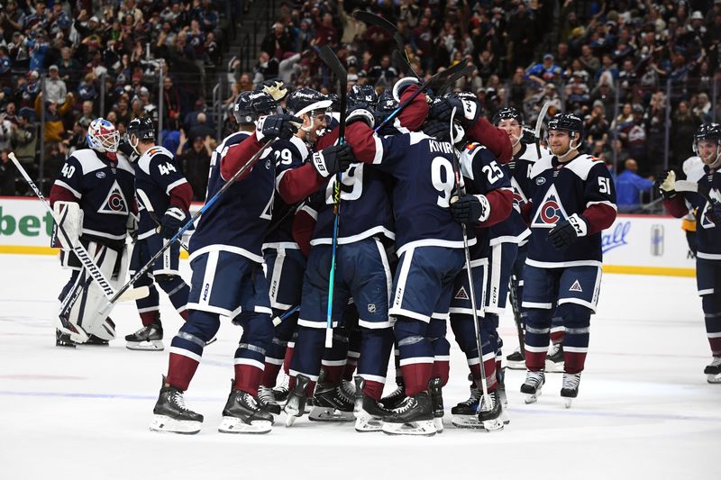 Nov 11, 2024; Denver, Colorado, USA; Colorado Avalanche players celebrate after the game-winning goal by defenseman Samuel Girard (49) in overtime against the Nashville Predators at Ball Arena. Mandatory Credit: Christopher Hanewinckel-Imagn Images