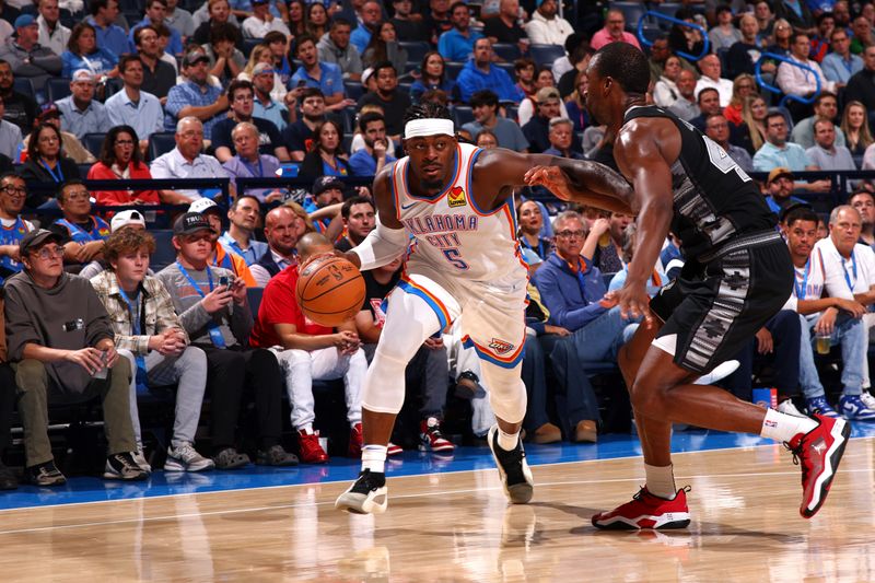 OKLAHOMA CITY, OK - OCTOBER 30: Luguentz Dort #5 of the Oklahoma City Thunder handles the ball during the game against the San Antonio Spurs on October 30, 2024 at Paycom Arena in Oklahoma City, Oklahoma. NOTE TO USER: User expressly acknowledges and agrees that, by downloading and or using this photograph, User is consenting to the terms and conditions of the Getty Images License Agreement. Mandatory Copyright Notice: Copyright 2024 NBAE (Photo by Zach Beeker/NBAE via Getty Images)