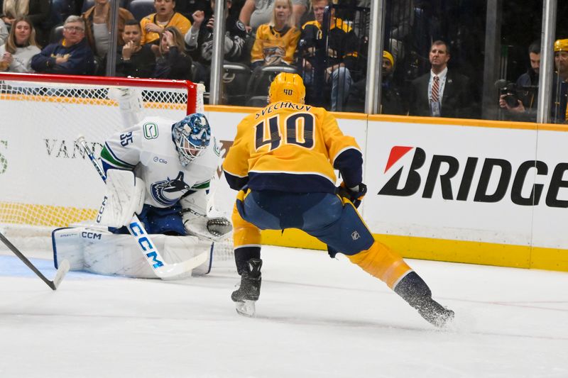 Oct 23, 2025; Nashville, Tennessee, USA; Vancouver Canucks goaltender Thatcher Demko (35) blocks the shot of Nashville Predators center Fedor Svechkiv (40)  during the first period at Bridgestone Arena. Mandatory Credit: Steve Roberts-Imagn Images